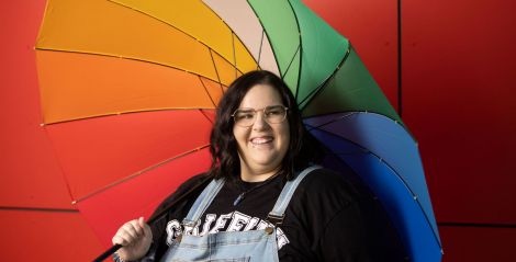 Griffith student holding rainbow umbrella