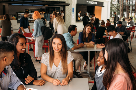 Women sitting at a table outside, talking
