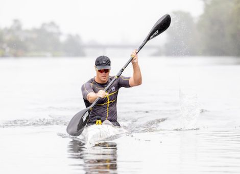 Male athlete paddling in a kayak