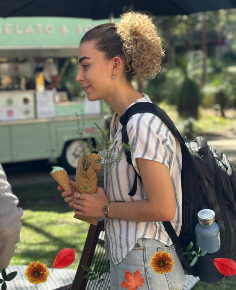 student holding a plant and an ice cream