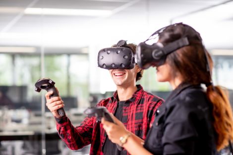Male and female student wearing virtual reality goggles