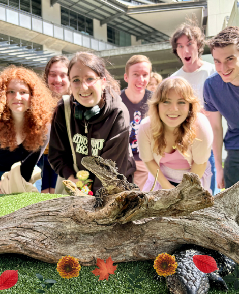 students posing with lizards