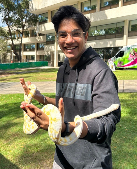 student holding yellow snake