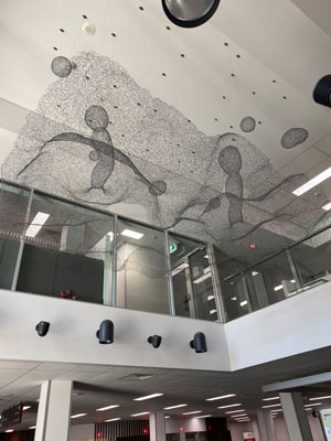 black wire sculpture hanging from ceiling