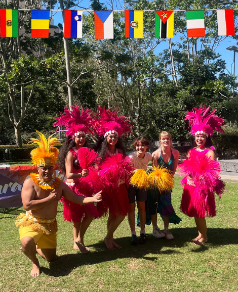 Students posing with Polynesian dancers