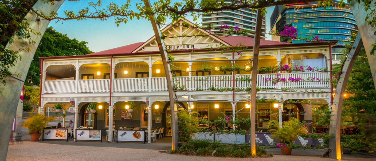 Photo of the Ship Inn building at night with dazzling lights and people