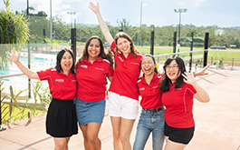 A group of students that are a part of the Griffith Mates team standing by the pool at Griffith University.
