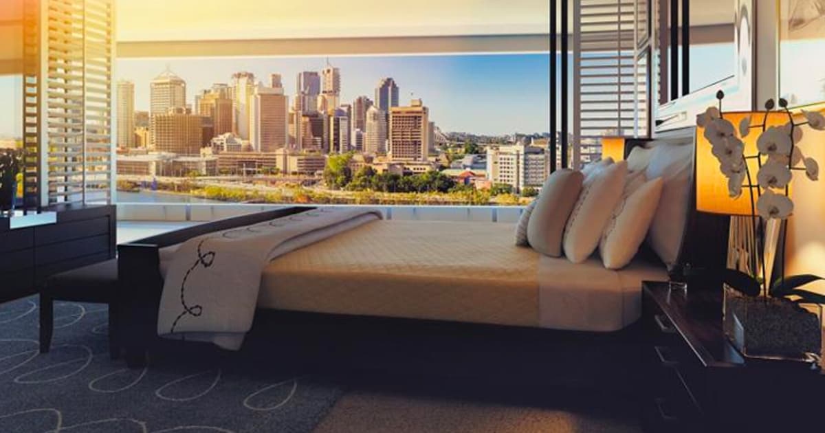 A photo of a hotel room with a nice bed