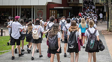 High school students walking into a building