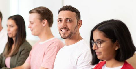 Women and men sitting at a desk