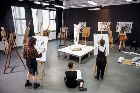 A group of students from above drawing on easels in the QCA drawing studio