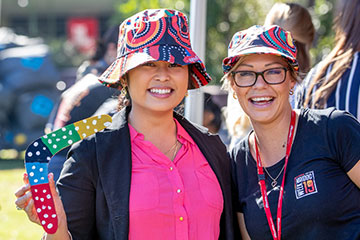 Two students wearing First Nation hats