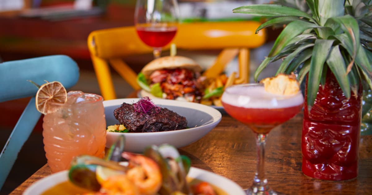 A photo of colourful foods and drinks at a table