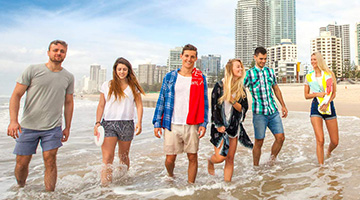 Students walking on a Gold Coast beach