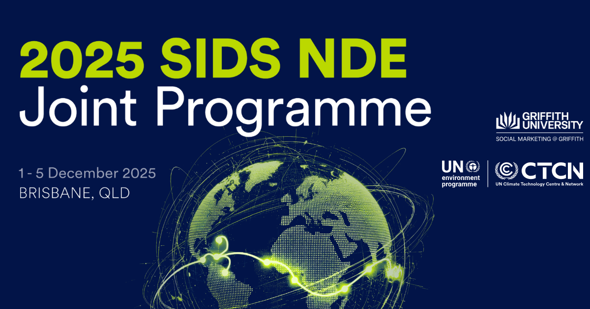 A large machine watering a field of crops