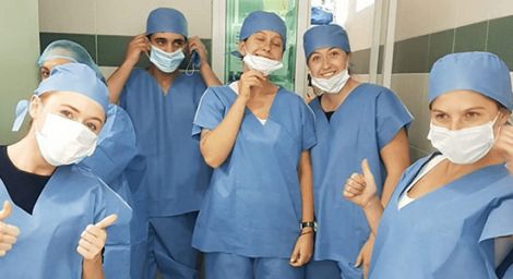 A group of doctors wearing personal protection gear