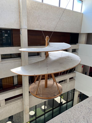 a wooden sculpture hanging from the ceiling