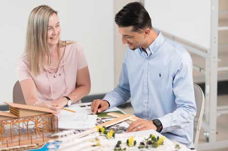 Man and woman sitting at a desk