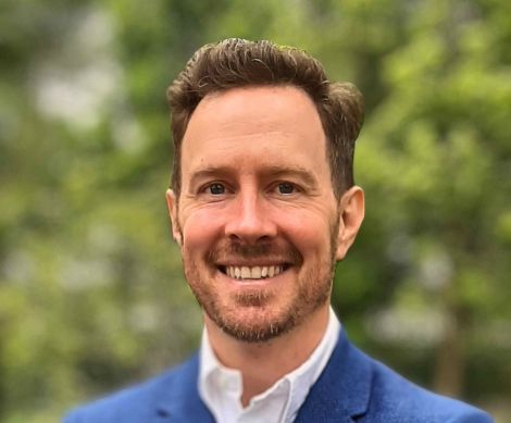 Young man with brown hair and smile