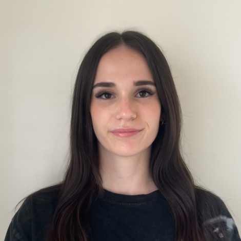 Image of Matilda O'Neil looking at the camera, standing in front of a white background