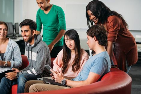 A group of students interacting with each others in common room