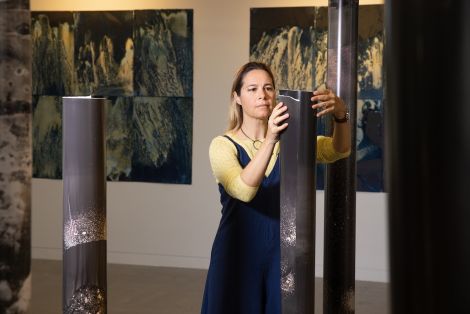 Student in the Grey Street Gallery displaying her sculptural works