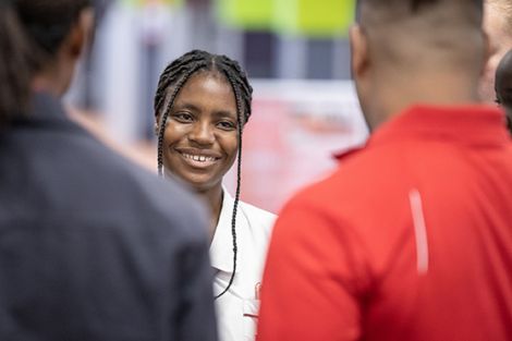 A female student chatting to two friends