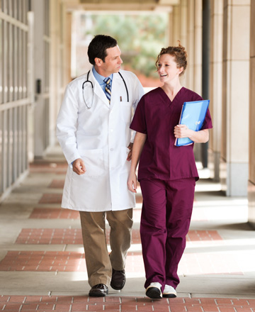 Two health professionals walking in a corridor