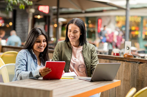 Two women sitting at a table, talking