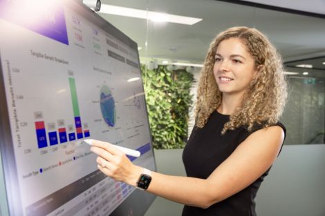 Female student writing on digital screen