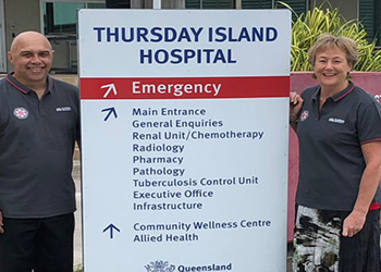 two researchers in front of the Thursday Island hospital