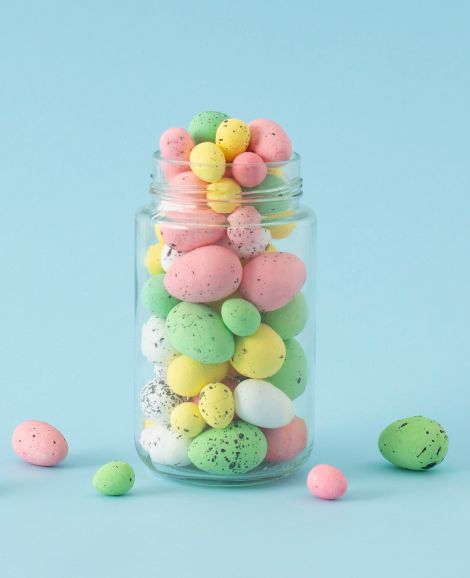 cotton candy character holding magnifying glass looking for easter eggs