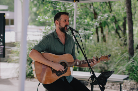 musician playing guitar and singing