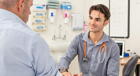 Griffith student Harrison Sheehy checking the pulse of a patient