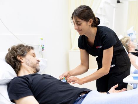 Nurse monitoring patient in hospital bed