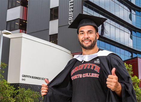 Ryan James standing in front of a university building wearing a Sports College jumper 