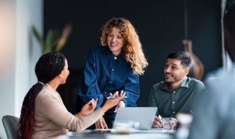 A group of diverse business professionals engaging in a collaborative meeting