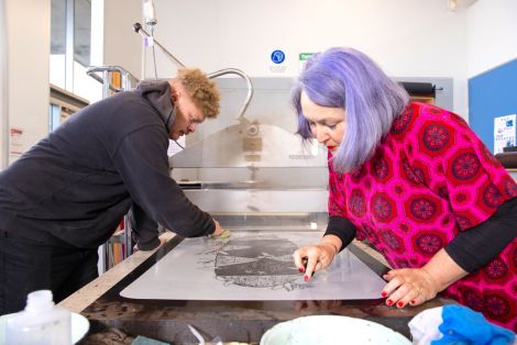 Two students working on prints in the QCA printmaking studio