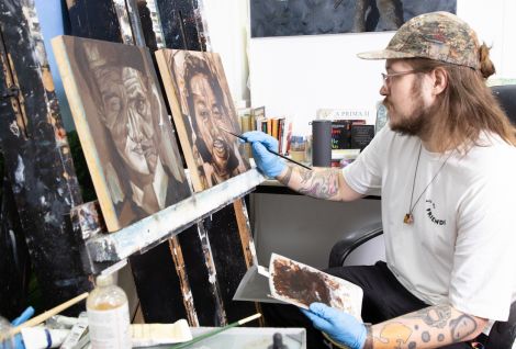 Painting student painting a picture on an easel