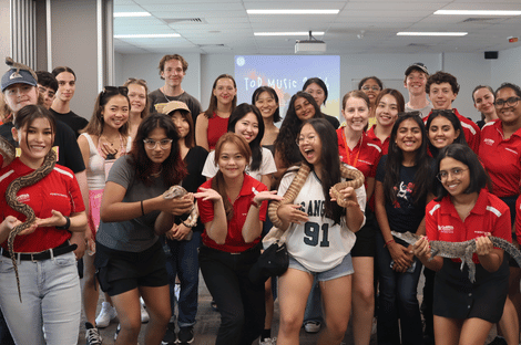 Group of students meeting Aussie reptiles including lizards, snakes, and crocodiles