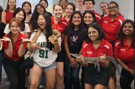 Group of students meeting Aussie reptiles including lizards, snakes, and crocodiles