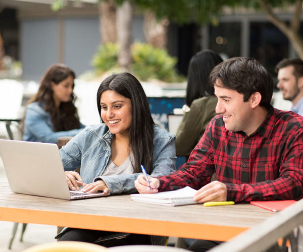 Students looking at laptop