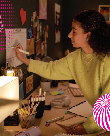 student writing on wallplanner