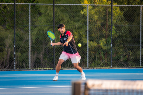 Club member hitting a tennis ball 