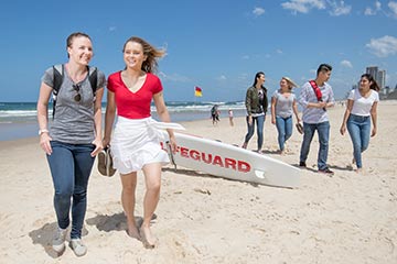 Students walking along the beach