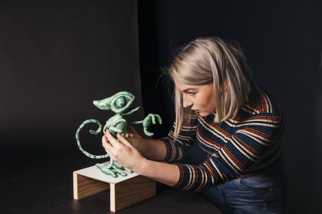 Student working with a character in the stop motion studio