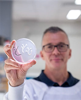 Researcher holding petri dish