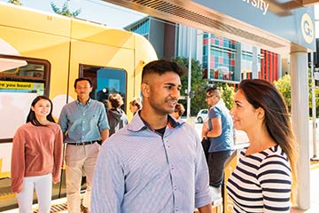 Students talking at the Griffith University tram stop