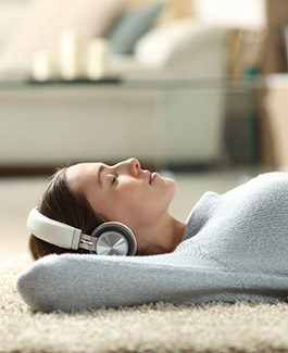 Relaxed women listening to music with headphones