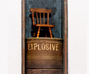 A woman does love a little home of her own, from Remembrances: Tribute Tins series, Melissa Stannard, Vintage ammunition tin, grenade casing and small timber chair, approx. 10cmW 42cmH 12cmD. Photo by Michelle Vine.